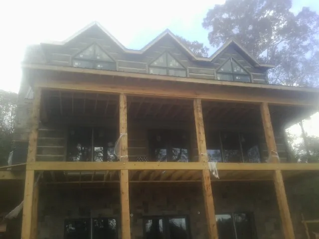 Dormers and porch framing on a large log home under construction in Gaithersburg