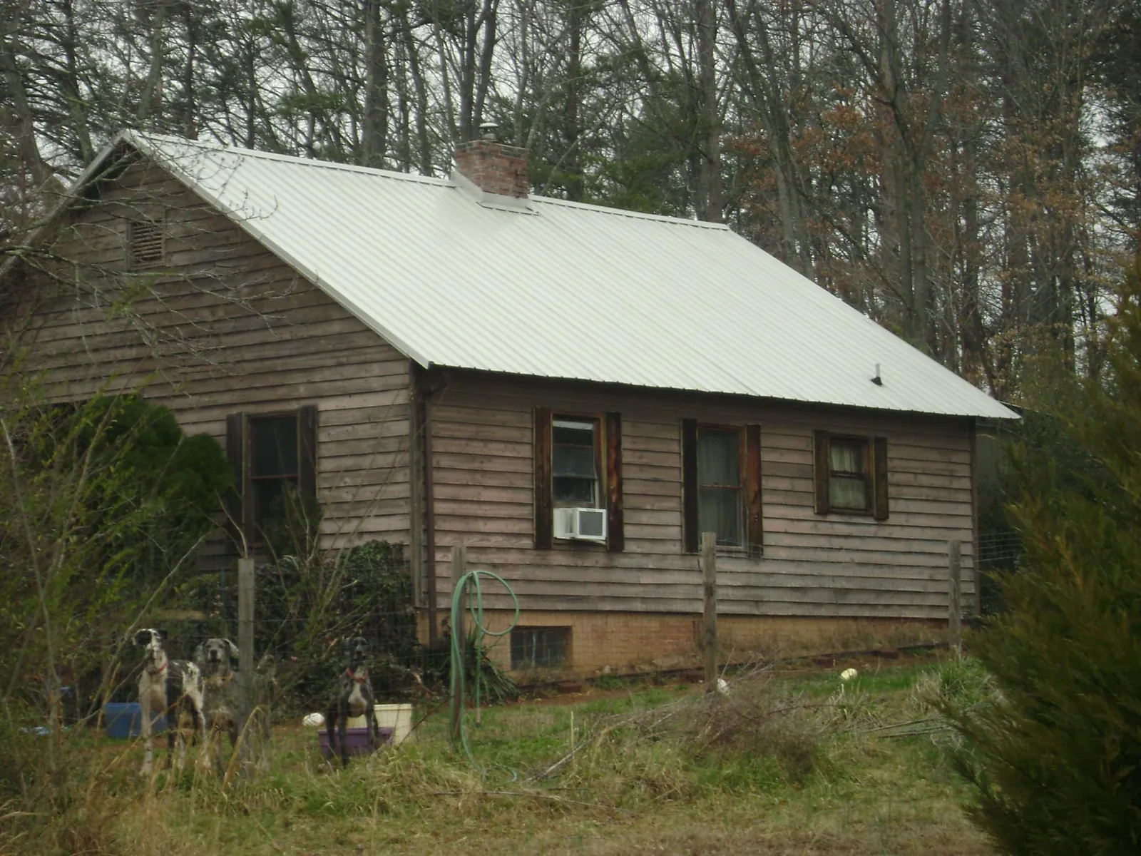 White metal roof on an old wood sided farmhouse, from a Asphalt Shingle Roof Repair job in Gaithersburg